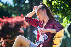 A runner hydrating during a sunny day
