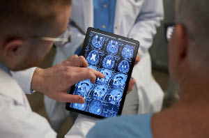 neurologist reviewing MRI scans with patient