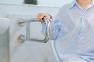 Parent helping child wear helmet to prevent head injury